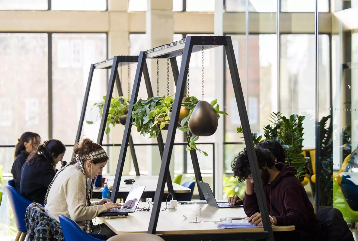 students working at a desk in the Manor Road Building